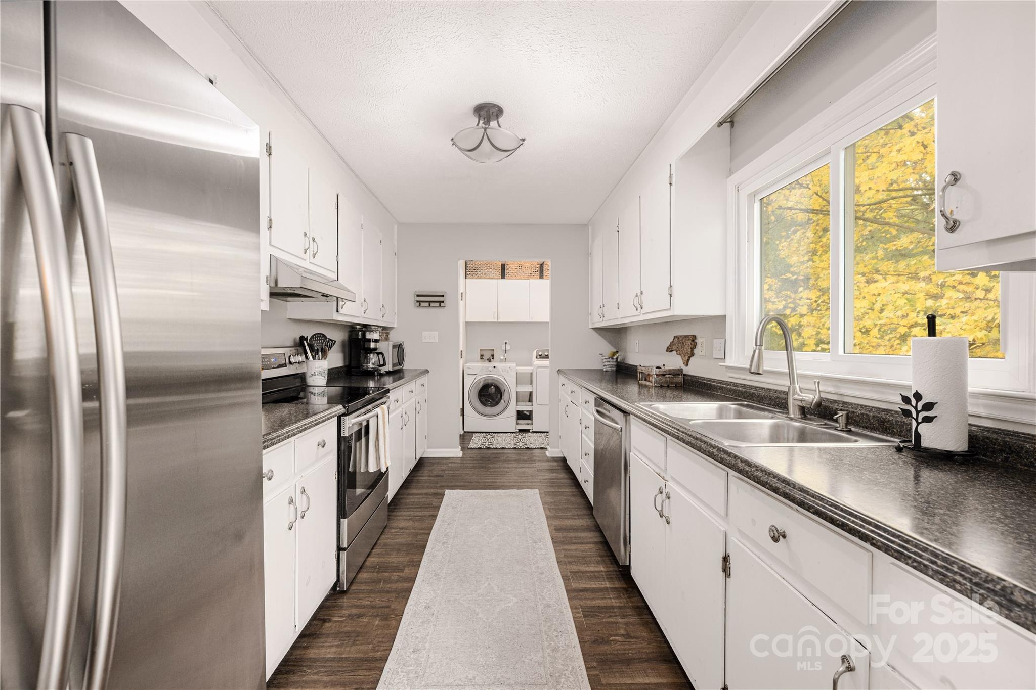 117 Clodfelter Road Mooresville, NC 28115 - Photo 12 of 39 a kitchen with stainless steel appliances a sink cabinets and a window