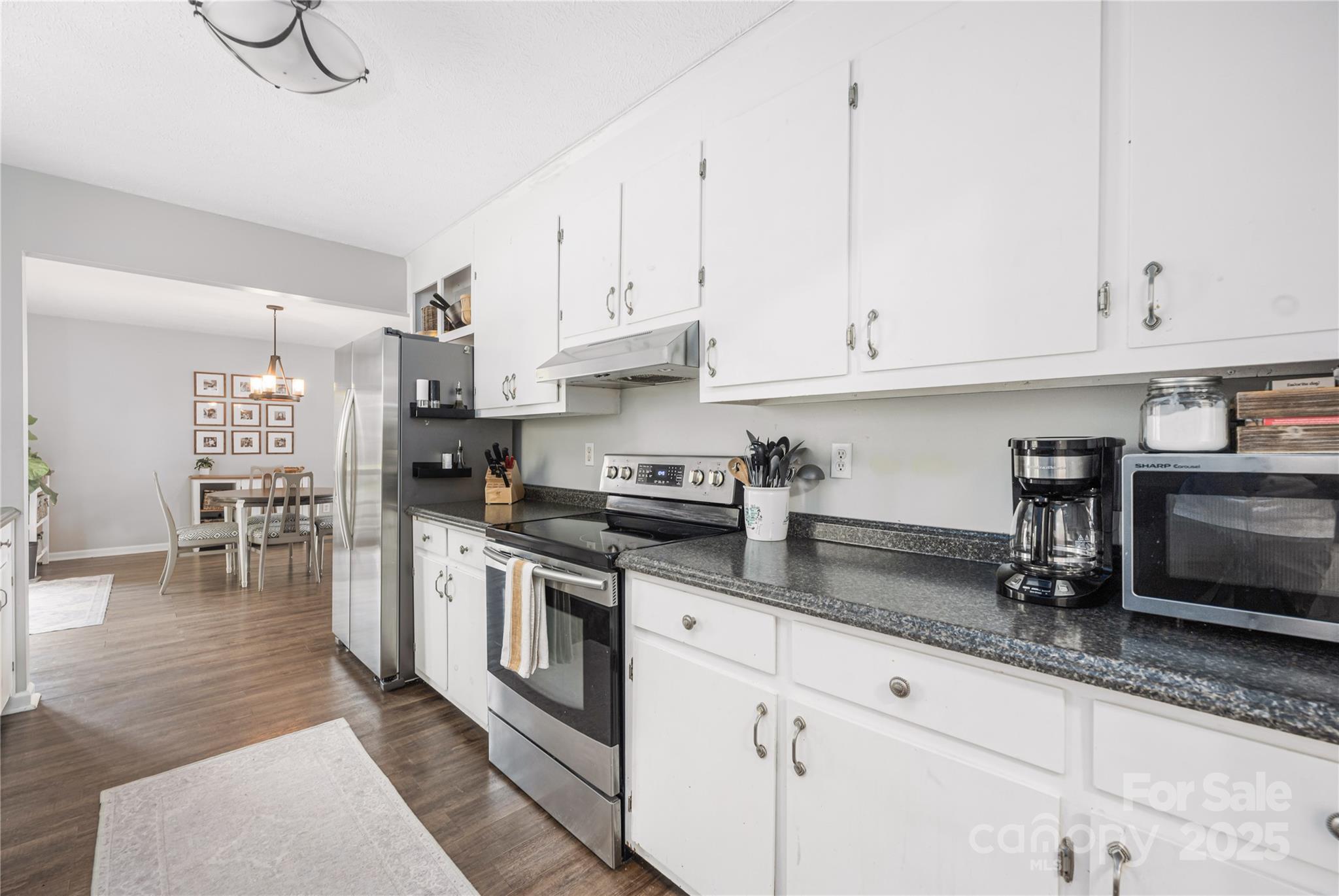 117 Clodfelter Road Mooresville, NC 28115 - Photo 13 of 39 a kitchen with granite countertop a sink stainless steel appliances and cabinets