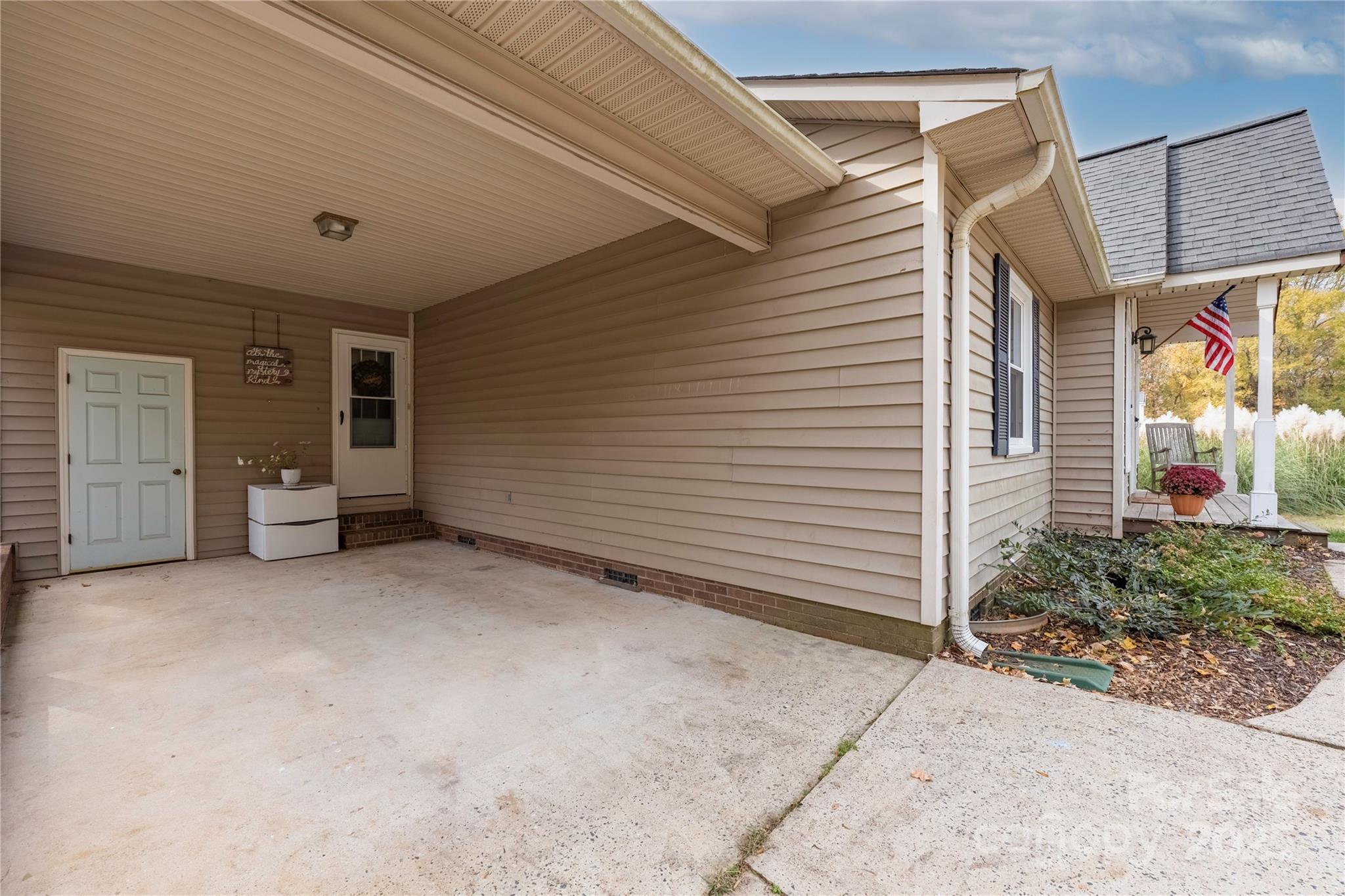 117 Clodfelter Road Mooresville, NC 28115 - Photo 4 of 39 a view of a patio with table and chairs and potted plants