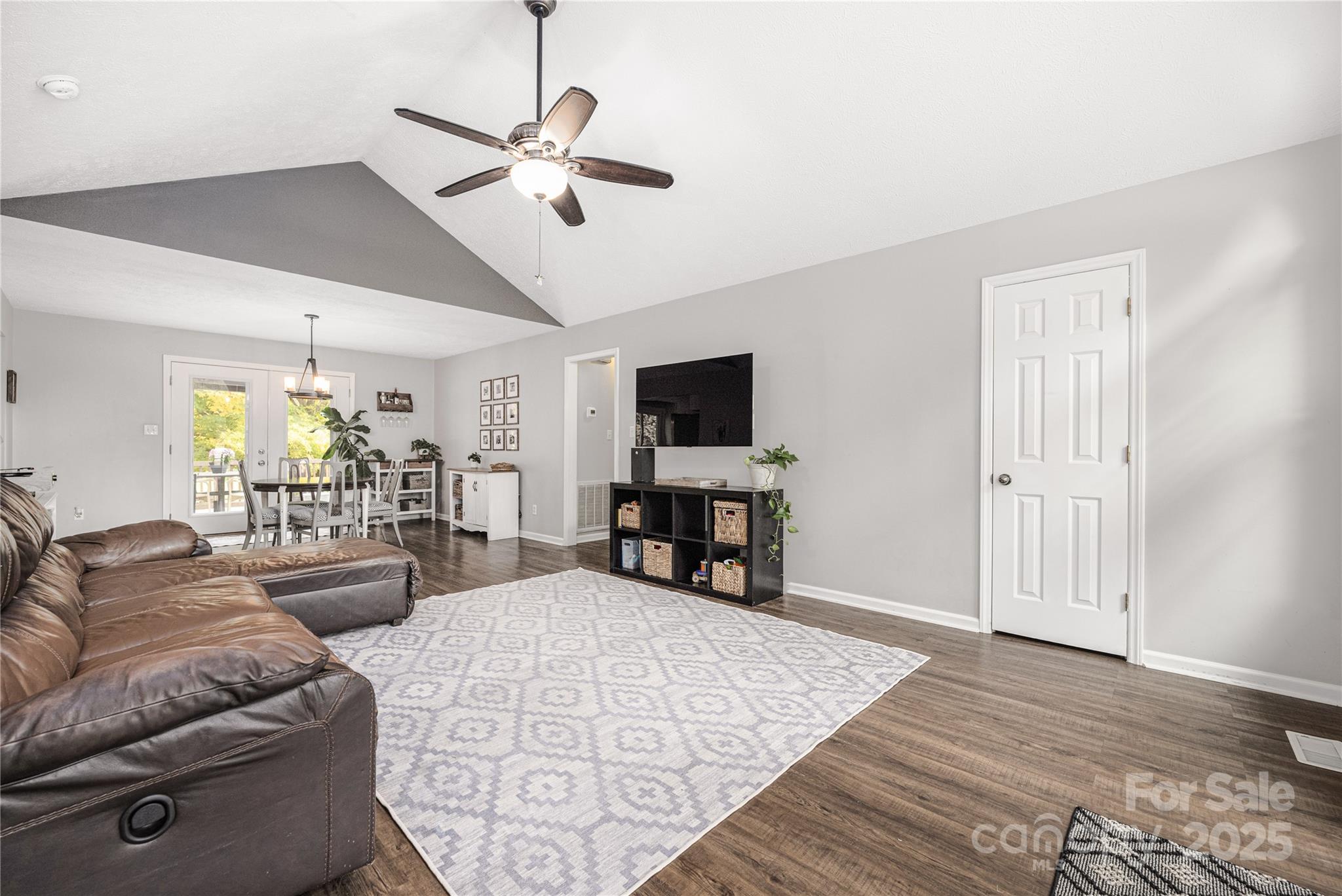 117 Clodfelter Road Mooresville, NC 28115 - Photo 8 of 39 a living room with furniture and a flat screen tv with wooden floor