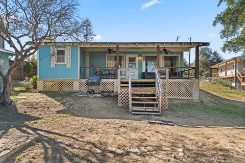 a view of a house with backyard and sitting area