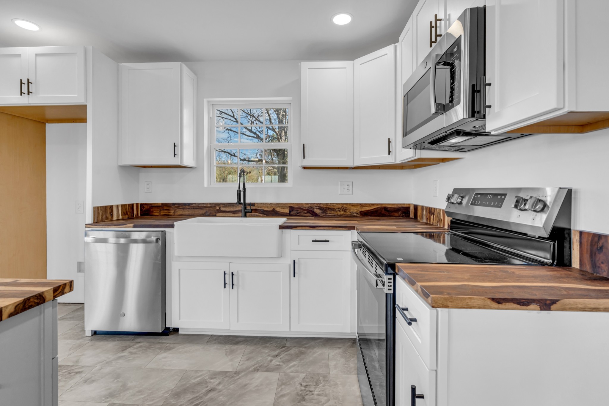 7159 C C C Road Fairview, TN 37062 - Photo 24 of 83 a kitchen with stainless steel appliances granite countertop a sink a stove a refrigerator a cabinets and wooden floor