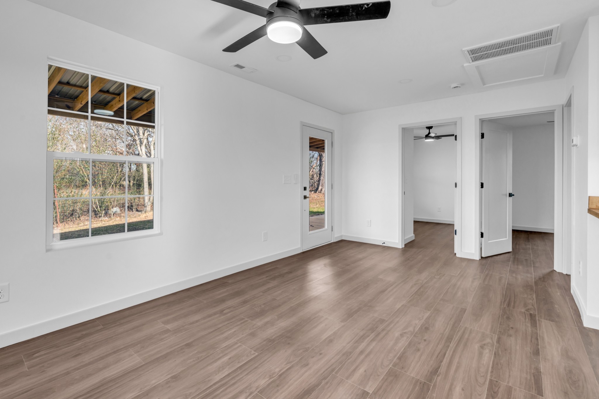 7159 C C C Road Fairview, TN 37062 - Photo 52 of 83 a view of an empty room with wooden floor and a window