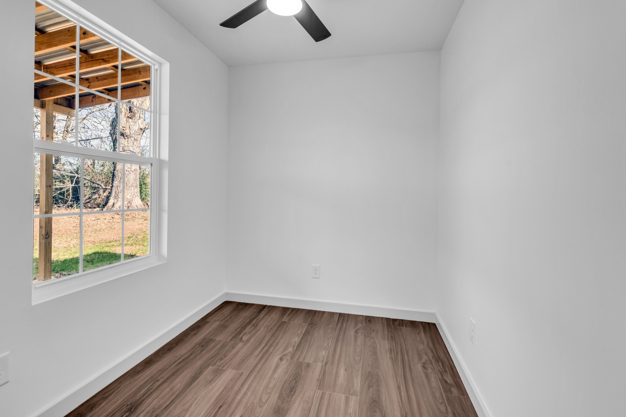 7159 C C C Road Fairview, TN 37062 - Photo 65 of 83 a view of an empty room with wooden floor and a window