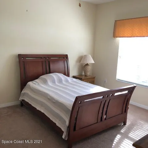 a view of a dining room with furniture and window