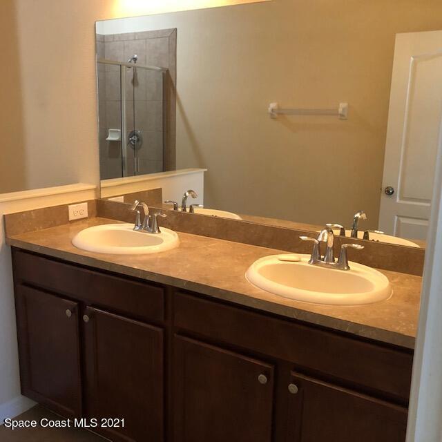 3731 Funston Circle Melbourne, FL 32940 - Photo 17 of 29 a bathroom with a sink and a mirror