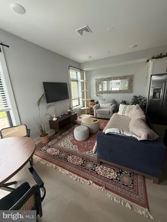 a living room with furniture a window and a flat screen tv