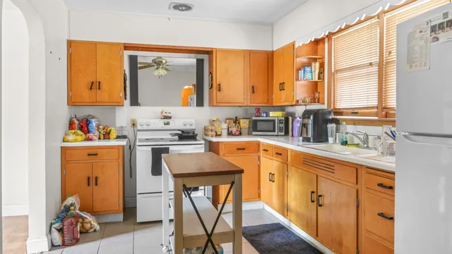 a kitchen with stainless steel appliances sink cabinets and window