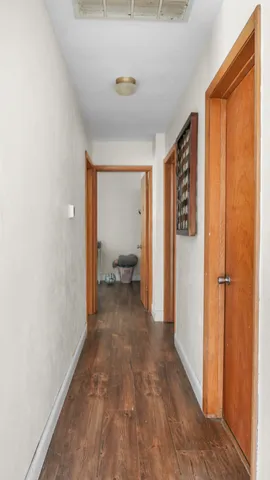 a view of a room with wooden floor