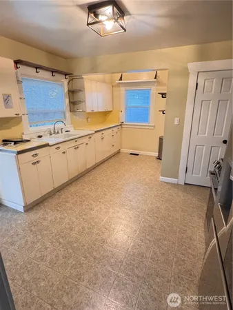 a white toilet sitting next to a bathroom sink and tub