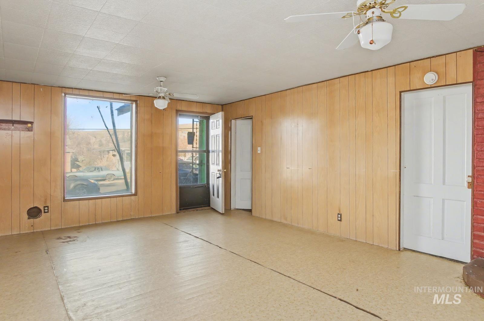 332 High Street Pomeroy, WA 99347 - Photo 5 of 23 Unfurnished room featuring ceiling fan and wood walls
