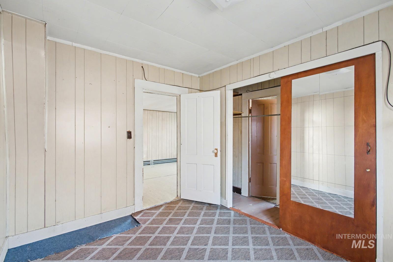 332 High Street Pomeroy, WA 99347 - Photo 8 of 23 Unfurnished bedroom with wood walls, a closet, and carpet flooring