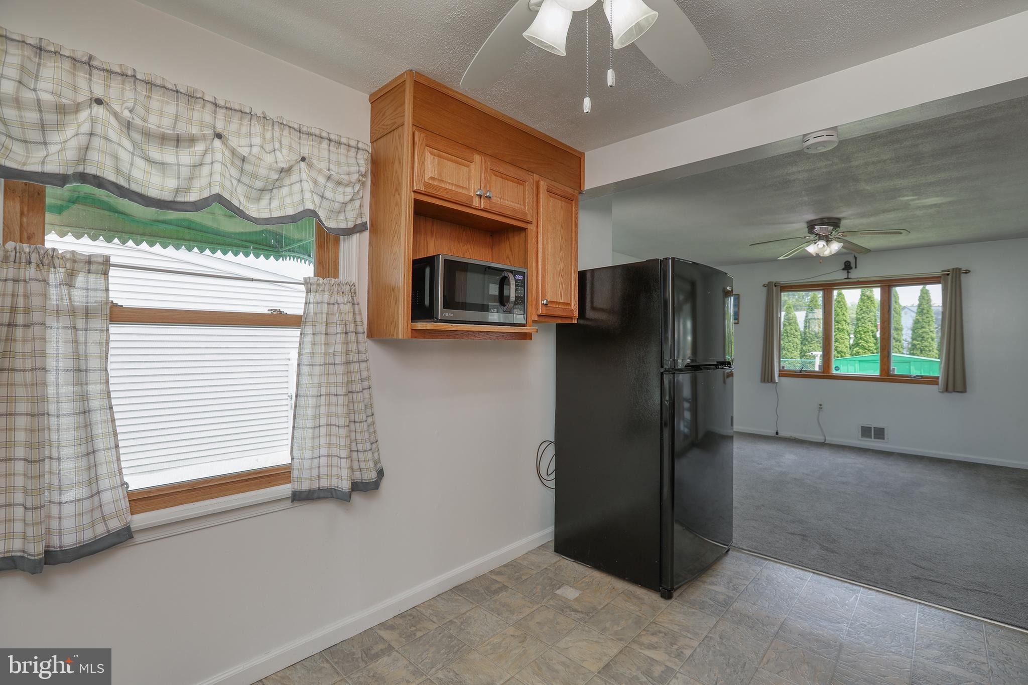 183 Franklyn Road Ewing, NJ 08628 - Photo 5 of 20 a view of a refrigerator in kitchen and an empty room