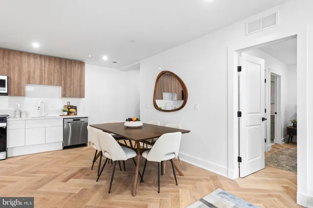a view of a dining room with furniture and a kitchen
