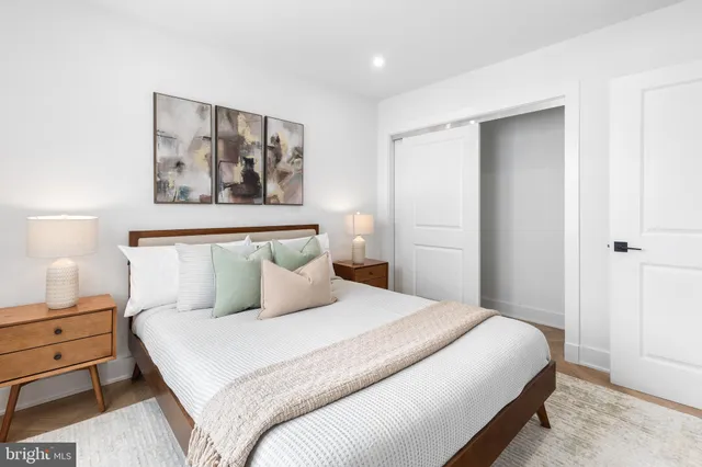 a bedroom with a bed and lamp