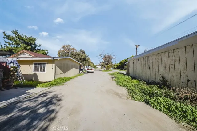 an aerial view of multiple houses with yard