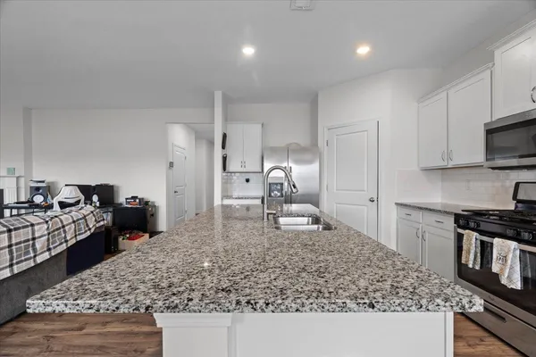 a kitchen with a sink stove and refrigerator