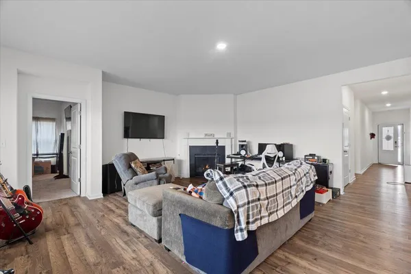 a living room with furniture and a view of kitchen