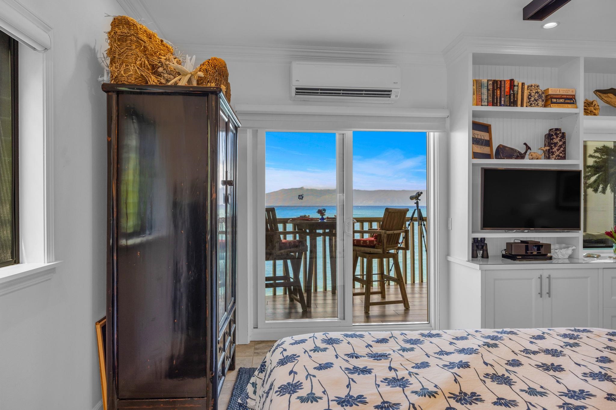 4435 Lower Honoapiilani Road, Unit 203 Lahaina, HI 96761 - Photo 12 of 32 a bedroom with a bed and a flat screen tv