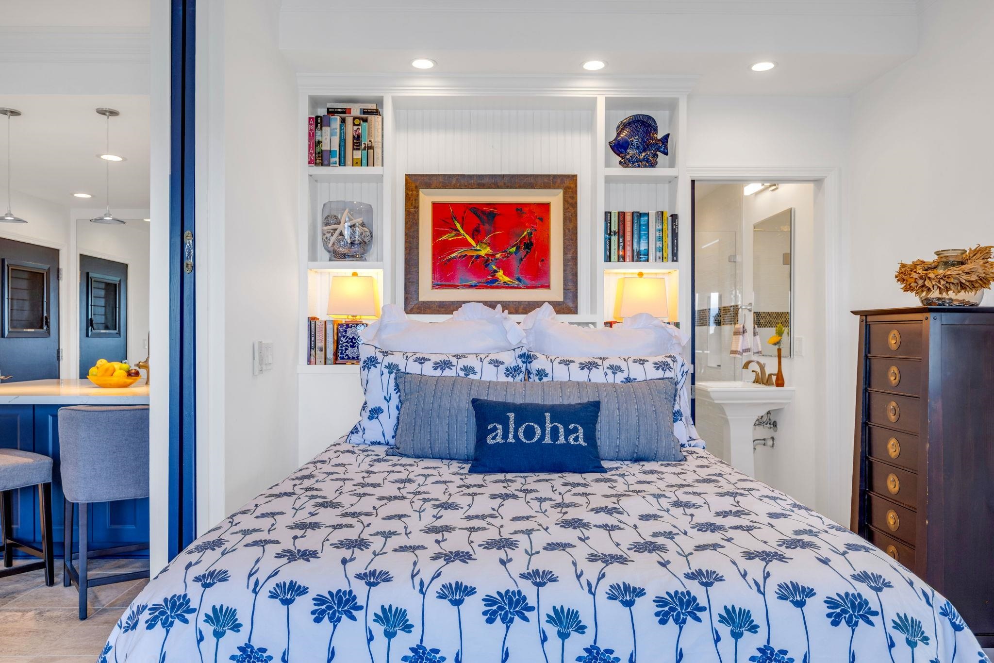 4435 Lower Honoapiilani Road, Unit 203 Lahaina, HI 96761 - Photo 13 of 32 a bedroom with a bed and painting on the wall
