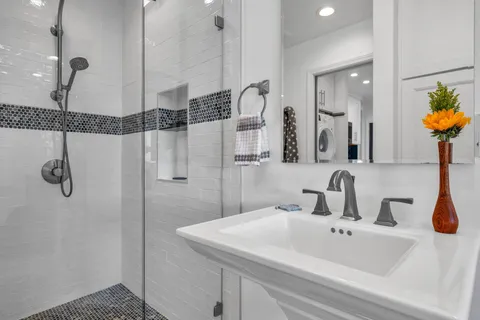 a view of entryway with wooden floor and mirror