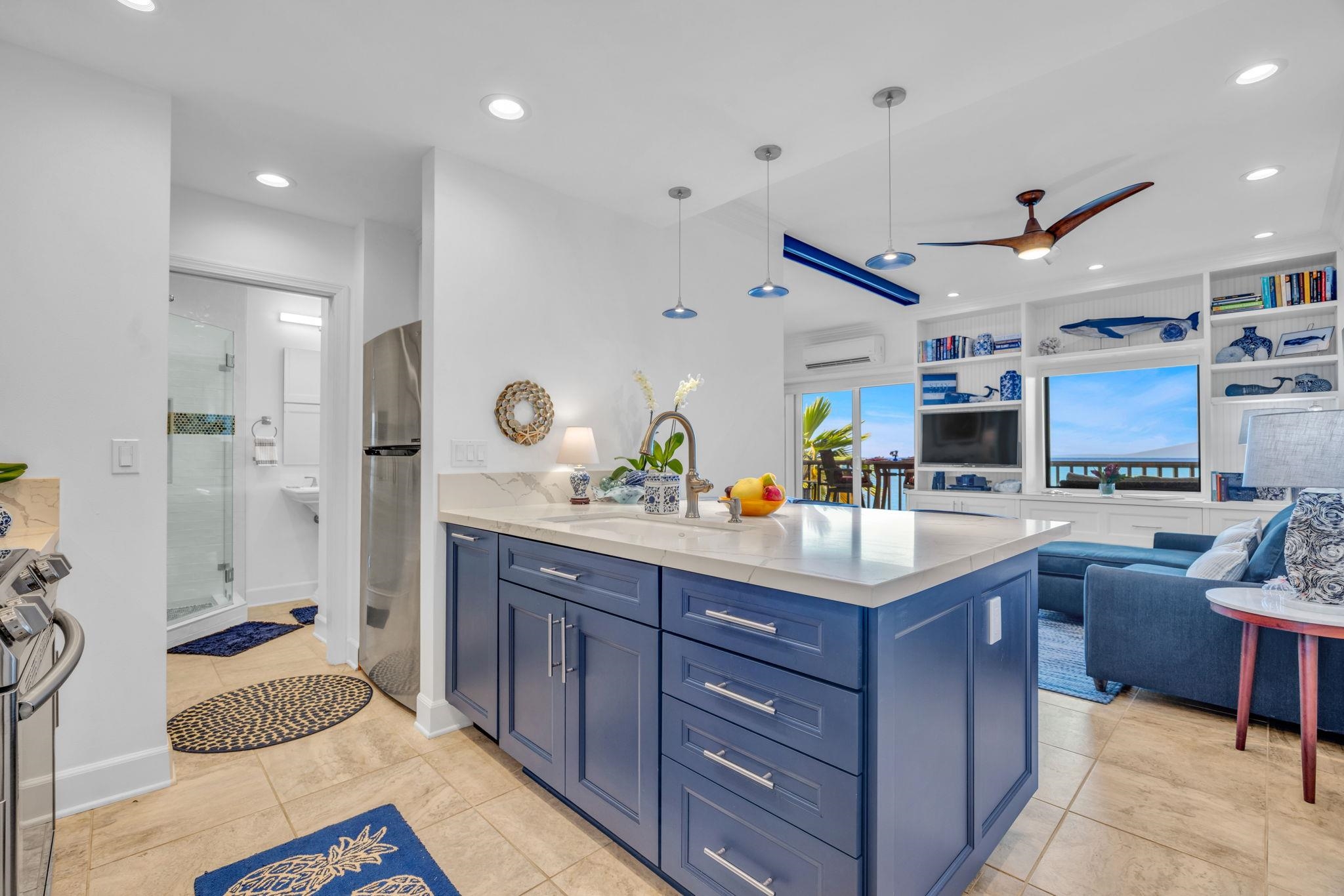 4435 Lower Honoapiilani Road, Unit 203 Lahaina, HI 96761 - Photo 7 of 32 a kitchen with stainless steel appliances kitchen island granite countertop a sink and a refrigerator
