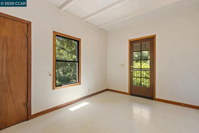 a dining room with wooden floor and large window