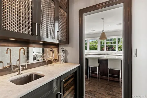 a kitchen with a sink a counter top space and a fireplace