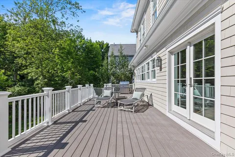 a view of a patio with a table chairs and a floor to ceiling window