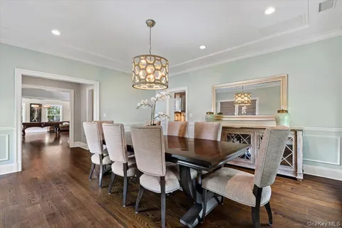 a view of a dining room with furniture wooden floor and chandelier