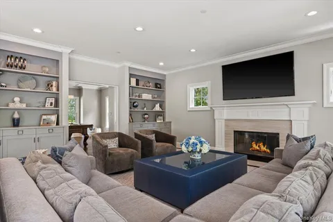 a living room with furniture fireplace and a flat screen tv