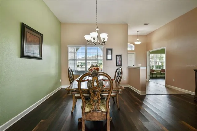 a view of a patio with table and chairs with wooden floor and fence