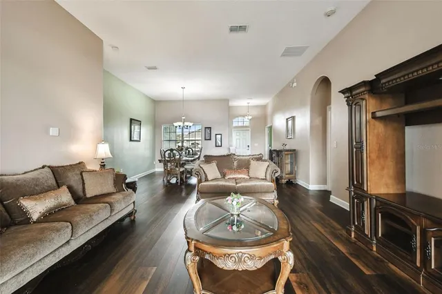 a front view of a house with a yard and potted plants