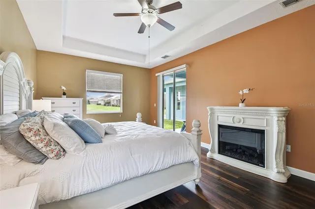 a kitchen with stainless steel appliances kitchen island granite countertop a stove a refrigerator a sink a dining table and chairs with wooden floor