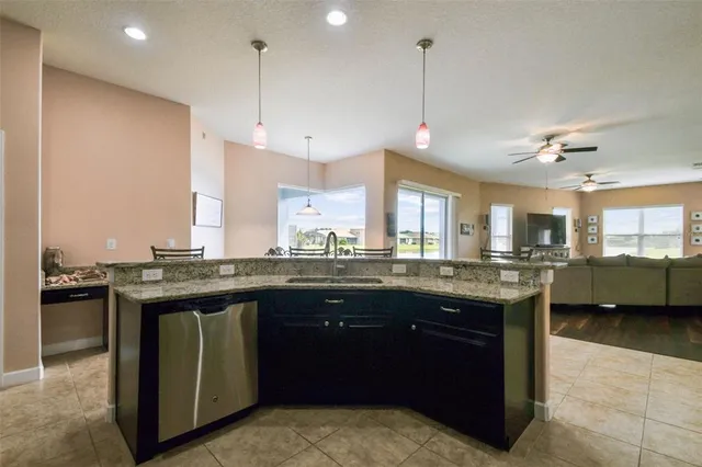 a view of a hallway with wooden floor and a bathroom