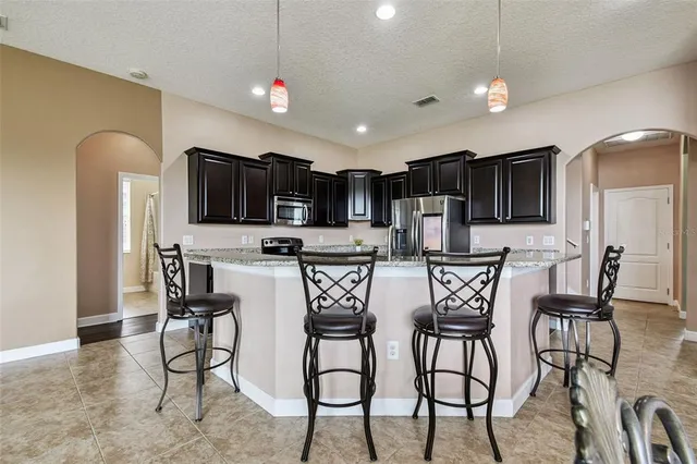 a view of a dining room with furniture a chandelier and wooden floor