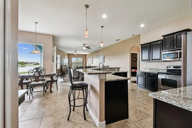 a view of a dining room with furniture a chandelier and wooden floor