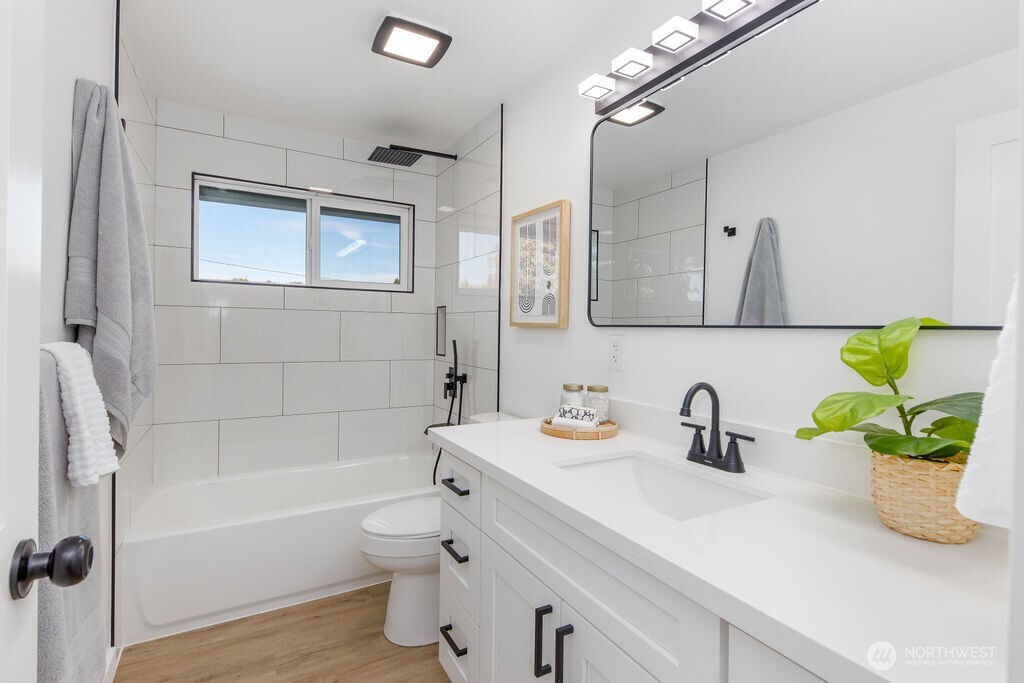 1103 Vashon Court Northeast Renton, WA 98059 - Photo 11 of 26 a bathroom with a sink a toilet and shower