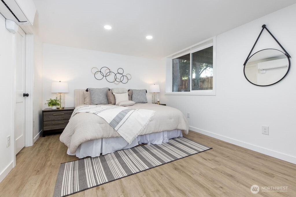 1103 Vashon Court Northeast Renton, WA 98059 - Photo 19 of 26 a bedroom with a bed and wooden floor