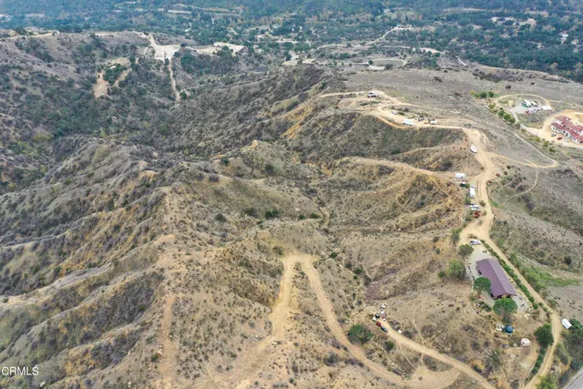 a view of a dry yard with mountains in the background