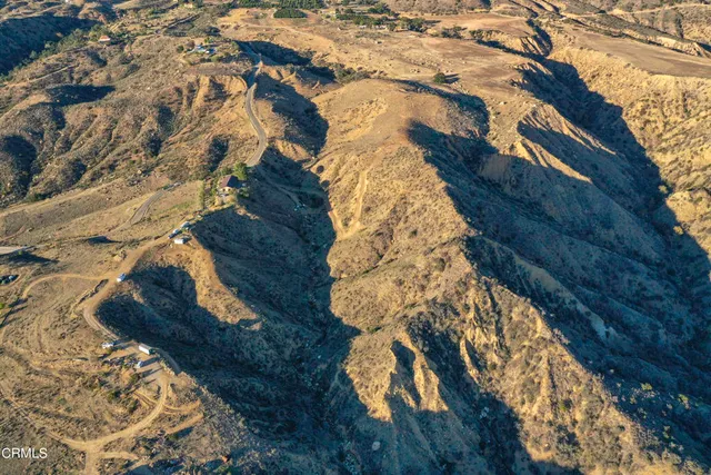 a aerial view of house with trees all around