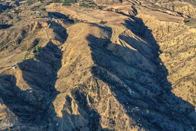 a aerial view of house with a tree