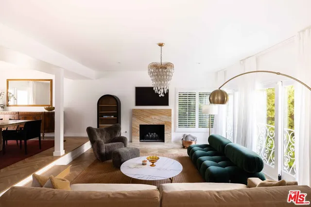 a living room with furniture fireplace and window