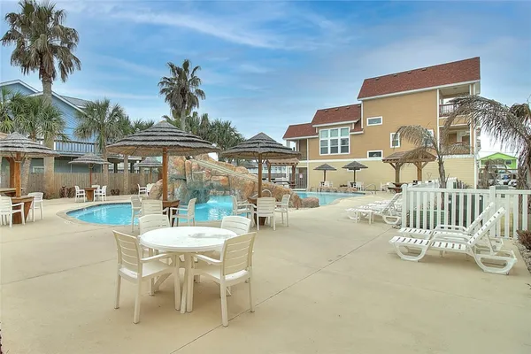 a view of a patio with a table and chairs