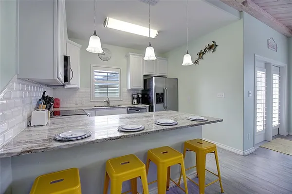 a kitchen with sink and refrigerator