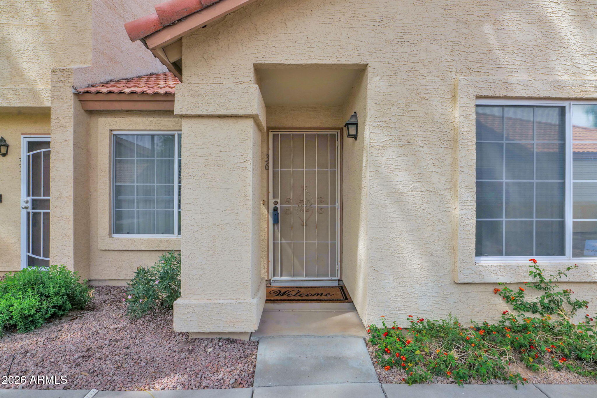 5808 East Brown Road, Unit 36 Mesa, AZ 85205 - Photo 1 of 29 a front view of a house with a yard