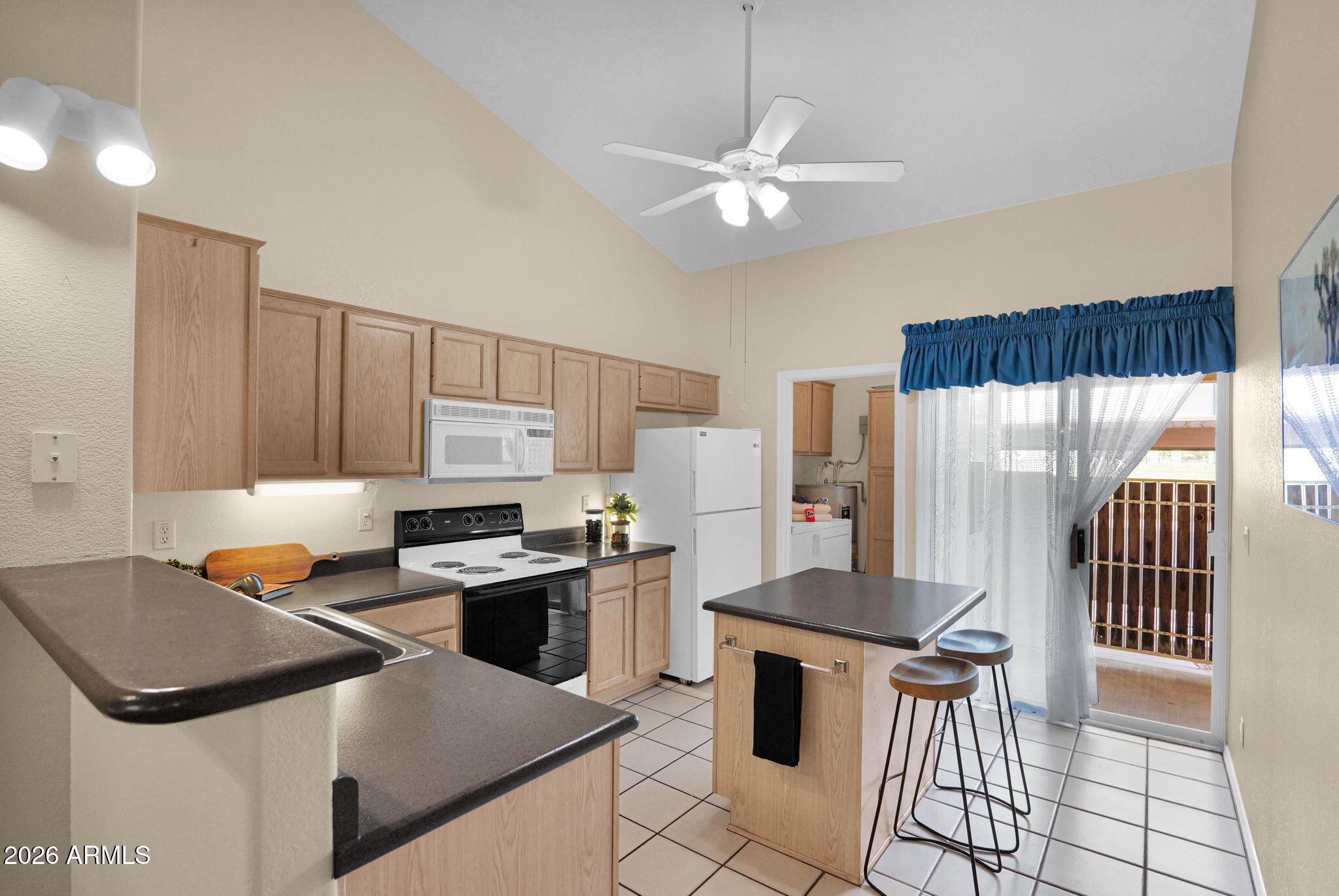 5808 East Brown Road, Unit 36 Mesa, AZ 85205 - Photo 11 of 29 a kitchen with stainless steel appliances granite countertop a stove a refrigerator a sink a stove and white cabinets