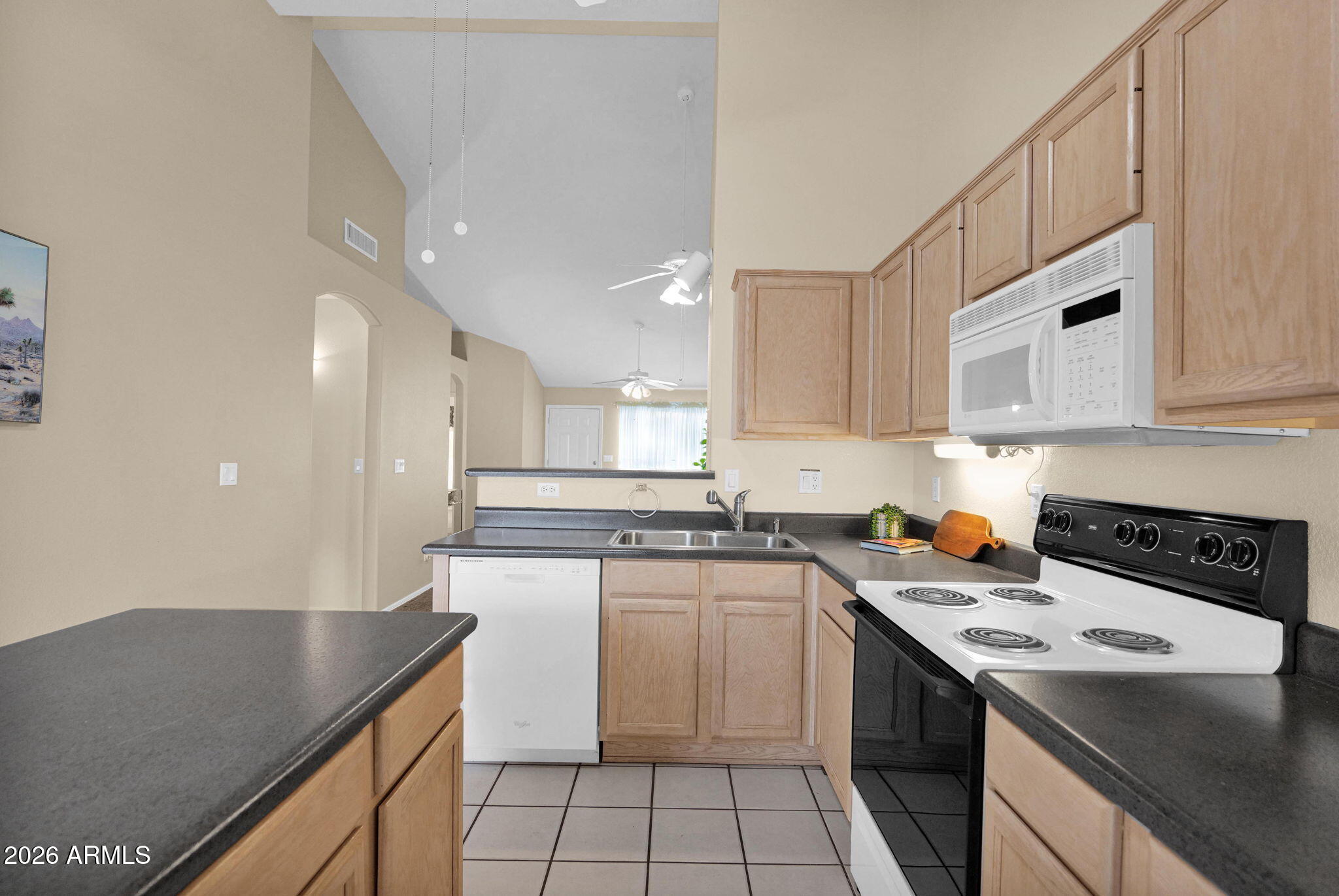 5808 East Brown Road, Unit 36 Mesa, AZ 85205 - Photo 13 of 29 a kitchen with a sink a stove and cabinets