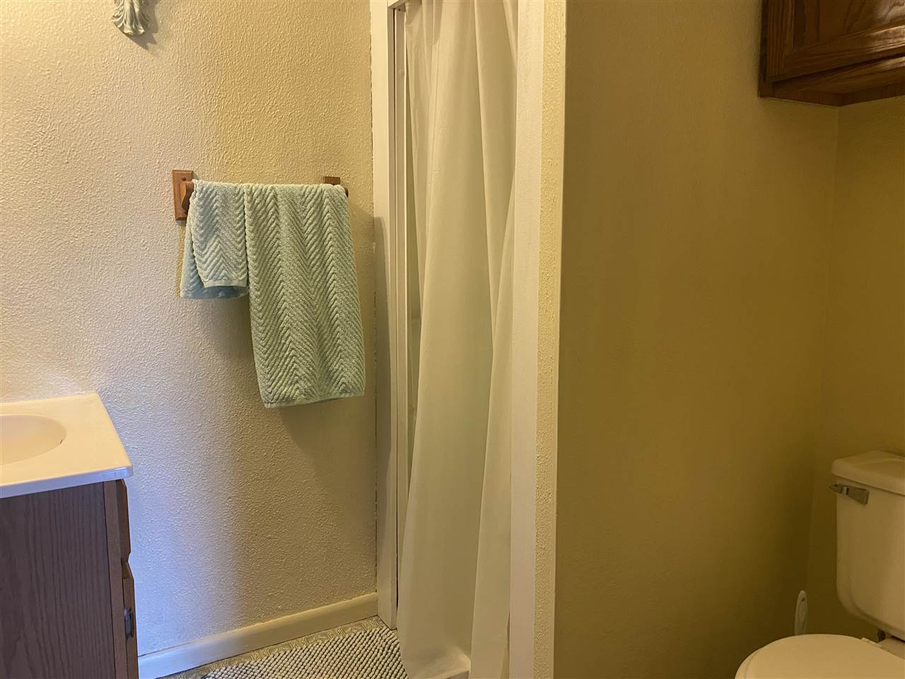 10979 2nd Street Roscoe, IL 61073 - Photo 11 of 30 a bathroom with a sink and mirror