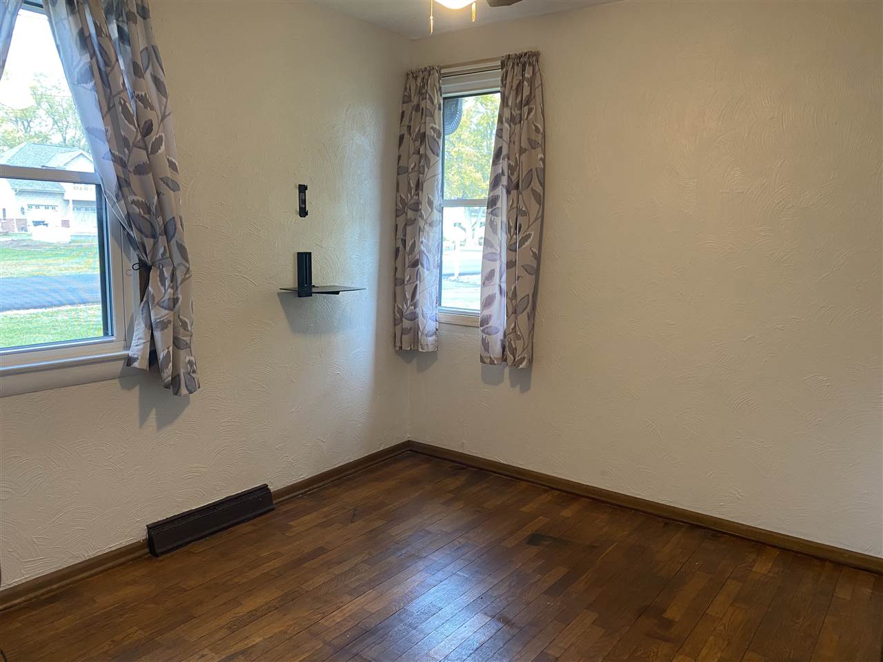 10979 2nd Street Roscoe, IL 61073 - Photo 12 of 30 an empty room with wooden floor and windows